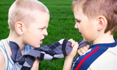 Children fighting over a sweater
